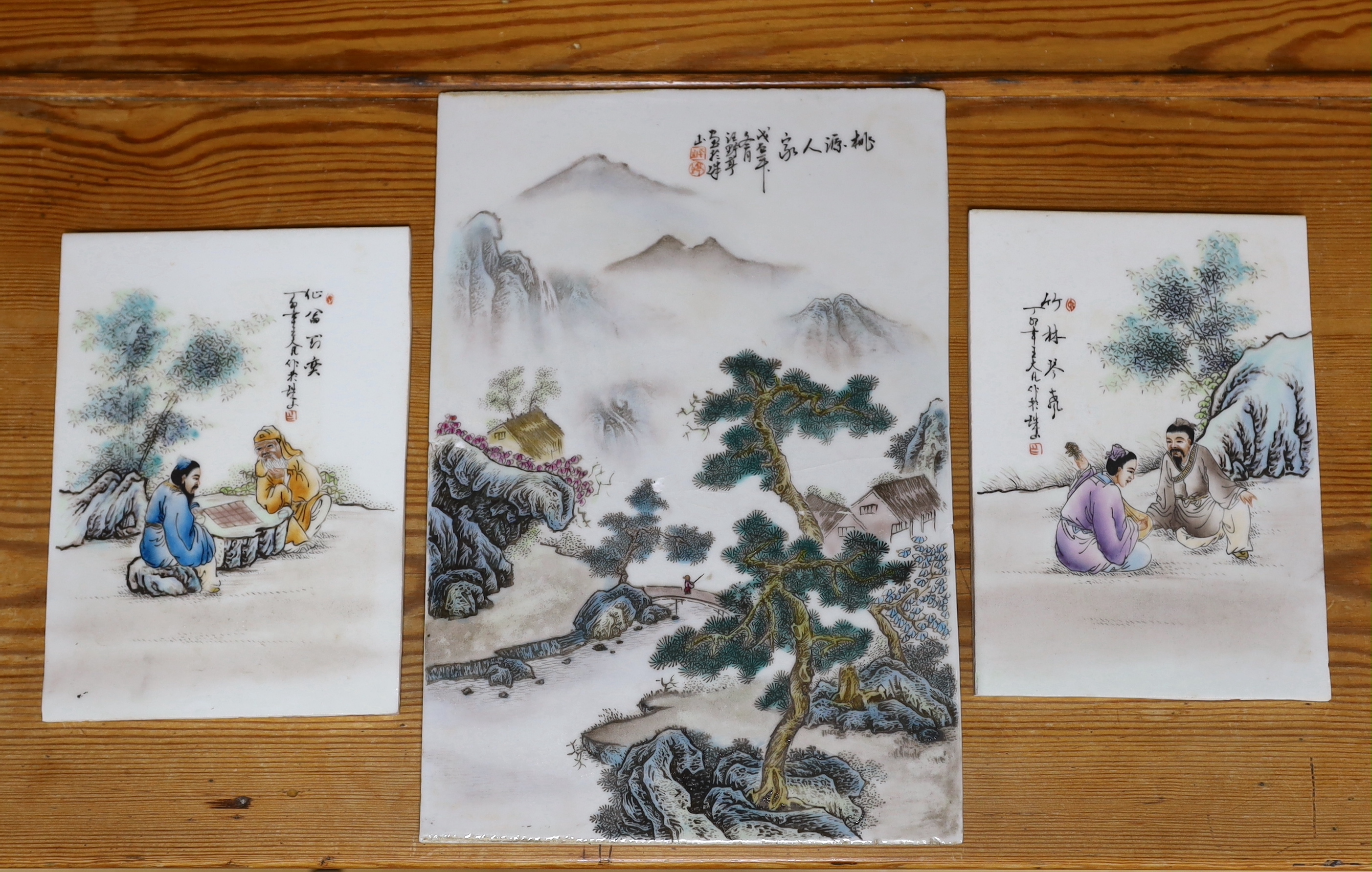 An early 20th century Chinese famille rose plaque and two others, largest 36cm high x 24.5cm wide